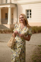 a lady in a yellow floral printed silk dress